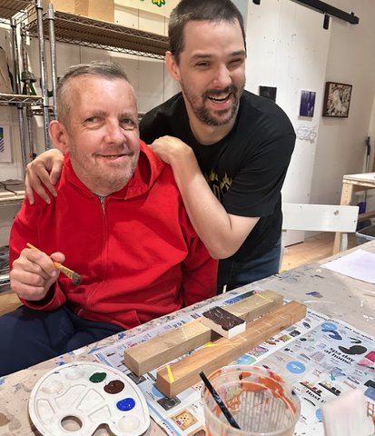 Two artists painting at Lightspire studio